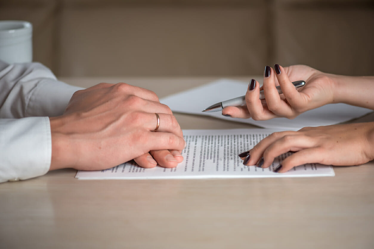 two people signing an agreement